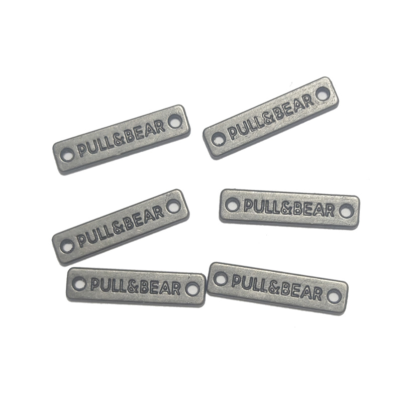 Two hole alloy plaque with concave logo